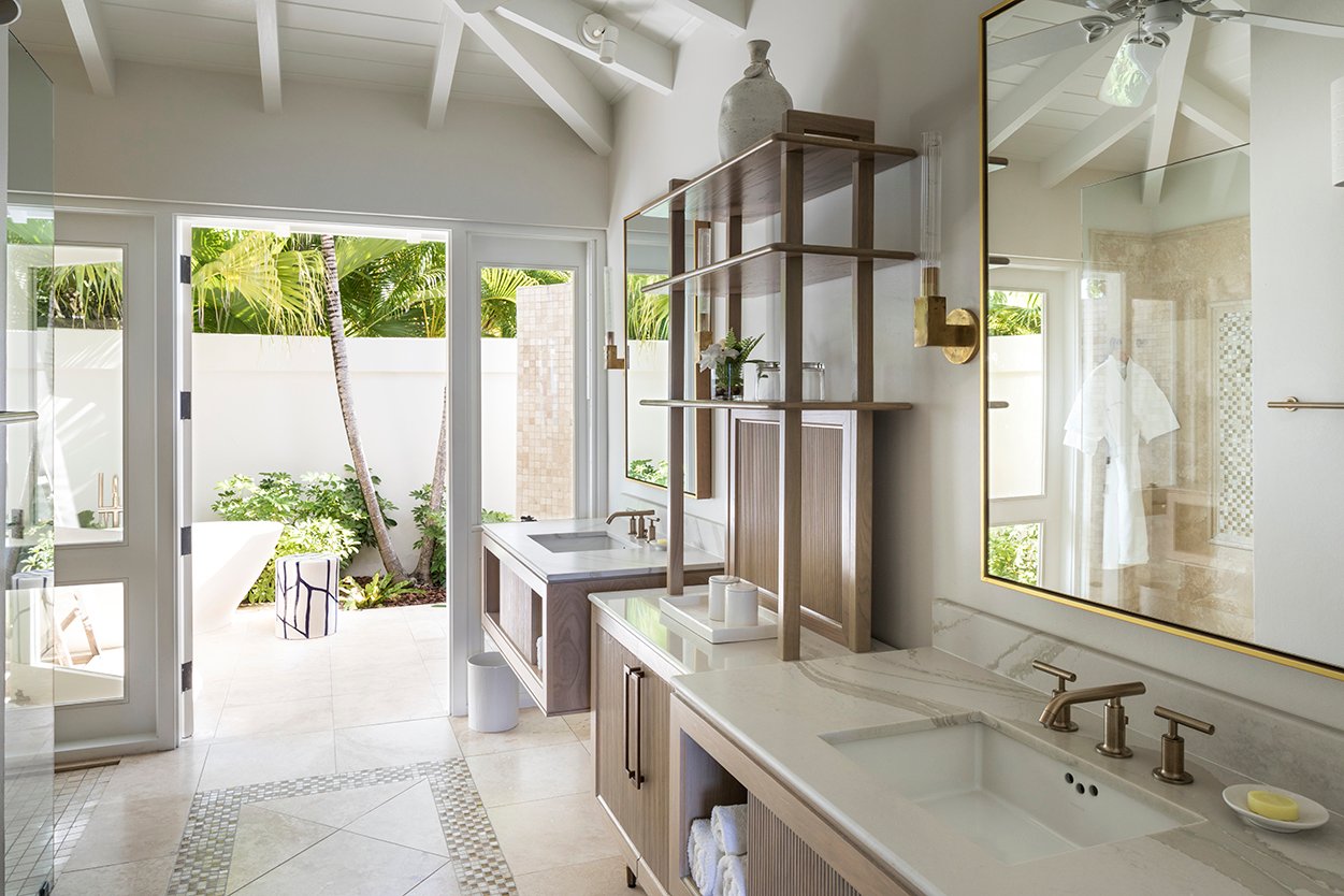 Jumby Bay Pond Bay Suites Ensuite Bathrooms with double vanities and etagere looking to outdoor shower and bath tub