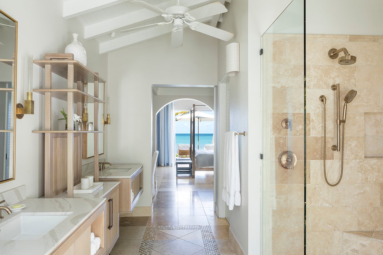 Jumby Bay Pond Bay Suite ensuite bathroom with double vanities looking out to the sea